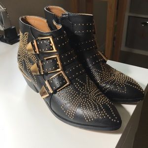 Black ankle boots with gold hardware detail